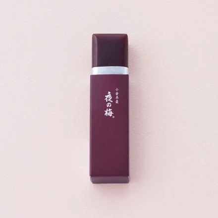 One Toraya petite yokan bar, Yoru no Ume flavor, on a pale pink background (Toraya photo).